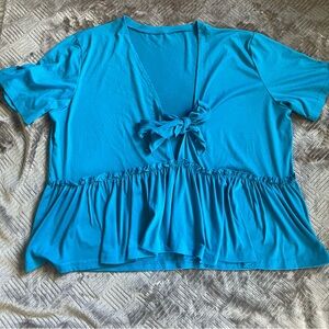 Blue short sleeve shirt. Deep V neck with faux bow tie. Ruffle bottom. SZ 2XL